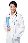 Smiling Young Doctor With A Folder Stock Photo