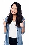 Smiling Young Girl Showing Two Thumbs Up Stock Photo