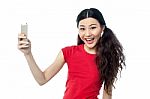 Smiling Young Girl Taking A Selfie Stock Photo