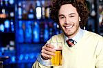 Smiling Young Man Holding A Glass Of Beer Stock Photo
