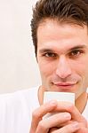 Smiling Young Man Holding Cup Stock Photo