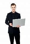 Smiling Young Man Holding Laptop Stock Photo