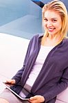 Smiling Young Woman Holding Digital Tablet Stock Photo