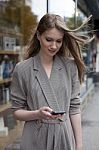 Smiling Young Women Using Cellphone Stock Photo