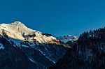 Snowy Mountain Tops In The Blue Sky Sun Stock Photo