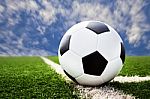 Soccer Ball On Grass Field With Blue Sky Stock Photo