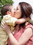 Son Kissing His Mom Stock Photo