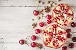 Still Life With Pomegranate , Cherry And Spices On The White Wooden Table Stock Photo