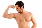 Strong Man Looking His Muscles Stock Photo