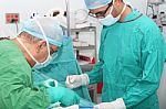 Student Assistant Helping Doctor In A Surgery Stock Photo