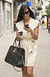 Stylish Young Business Woman Texting In City Stock Photo