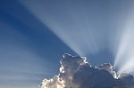Sun Rays Come Through Clouds Stock Photo