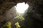 Sunlight Through A Cave Hole In Thailand Stock Photo