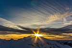 Sunset Over The Snowy White Alpine Mountains Stock Photo