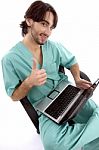 Surgeon On Laptop With Thumbs Up Stock Photo