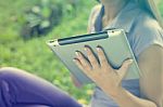 Tablet Computer On Hand Of Beautiful Young Woman In Park Stock Photo