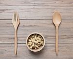 Tablets In Wood Bowl ,spoon On Wooden Background Stock Photo