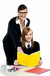 Teacher Instructing Student And Helping Her Stock Photo