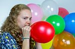 Teenage Girl Blowing Inflating Colored Balloons Stock Photo