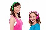 Teenage Sisters Listening To Music Stock Photo