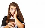 Teenager Girl Looks At Smartphone Display In Surprise Stock Photo