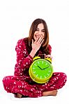Teenager Sitting With Alarm Clock Stock Photo