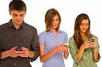 Teenagers Reading Sms Stock Photo