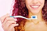 Teeth Brush And Girl's Smile Behind Stock Photo