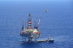 The Offshore Drilling Oil Rig And Supply Boat Side View Stock Photo
