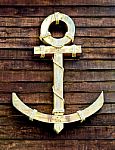 The Old Wooden Anchor On Wood Wall Background Stock Photo