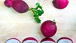 The Radishes On The Wooden Background Stock Photo