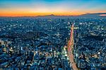 The Sun Sets Over The Cityscape Of Tokyo Stock Photo
