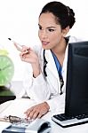 Thinking Doctor With Her Pen Stock Photo