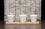 Three White Cups With Bamboo Backdrop Stock Photo