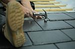 Tiler Laying Tiles On Roof Stock Photo