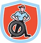 Tireman Mechanic With Tire Cartoon Shield Stock Photo