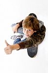 Top View Of Boy Sitting On Skateboard Stock Photo