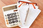 Top View Of Calculator, Pen, Eyeglasses And Bank Account Passboo Stock Photo