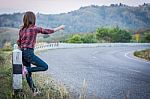 Tourist Hitchhiking Woman Standing On The Road In The Mountains Stock Photo
