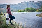 Tourist Hitchhiking Woman Standing On The Road In The Mountains Stock Photo