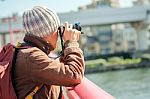 Tourist Man Taking Photo At The Bridge Under Sun Light Stock Photo