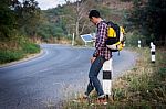 Tourists Man Look At A Map On The Tablet On Mountain Roads Stock Photo
