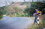 Tourists Man Walk Along Mountain Roads Stock Photo