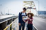Tourists Read The Map On The Bridge Stock Photo