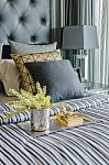 Tray Of Book With Vase Of  Plant On Bed In Luxury Bedroom Stock Photo