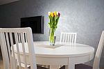 Tulips On White Dining Table Stock Photo