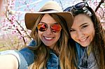 Two Beautiful Young Women Taking A Selfie In The Field Stock Photo