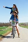 Two Beautiful Young Women With A Vintage Bike In The Field Stock Photo