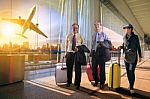 Two Business Man And Woman With Traveling Luggage Walking In Airport Teminal Stock Photo