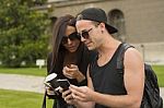 Two Cheerful Friends Taking Photos Of Themselves On Smart Phone Stock Photo